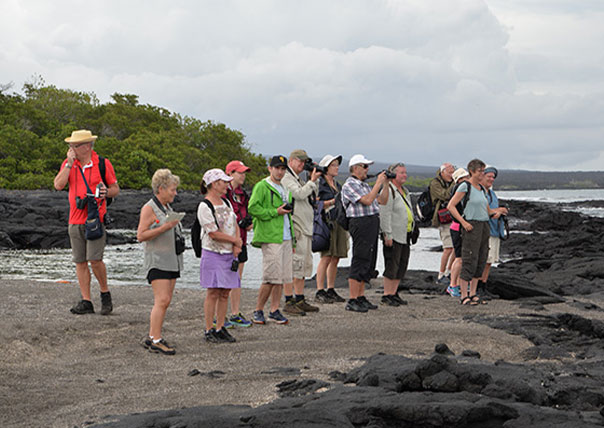 people taking fotos in a galapagos island beach of galapagos islands