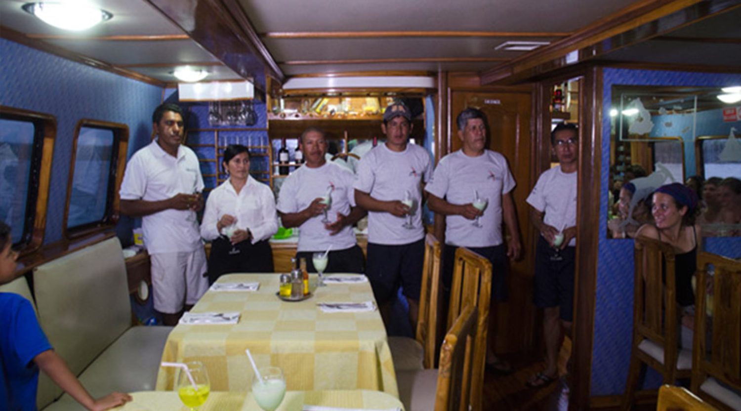 golondrina yacht crew in the dining room of galapagos islands