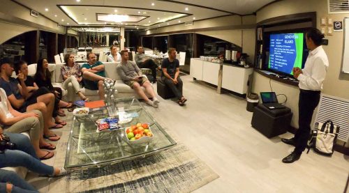 passenger in the living room of grand majestic galapagos yacht of galapagos islands tours