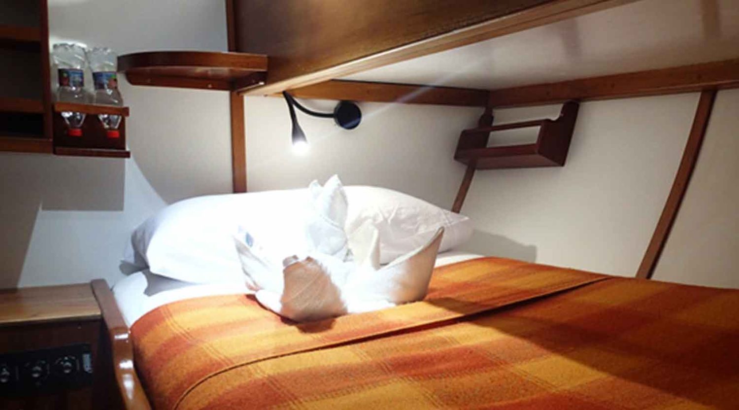 twiin size bed bedroom of samba yacht of galapagos islands