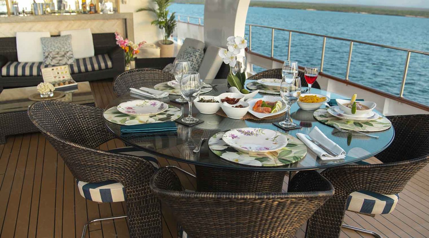 outdoor dining room of stella maris yacht of galapagos islands