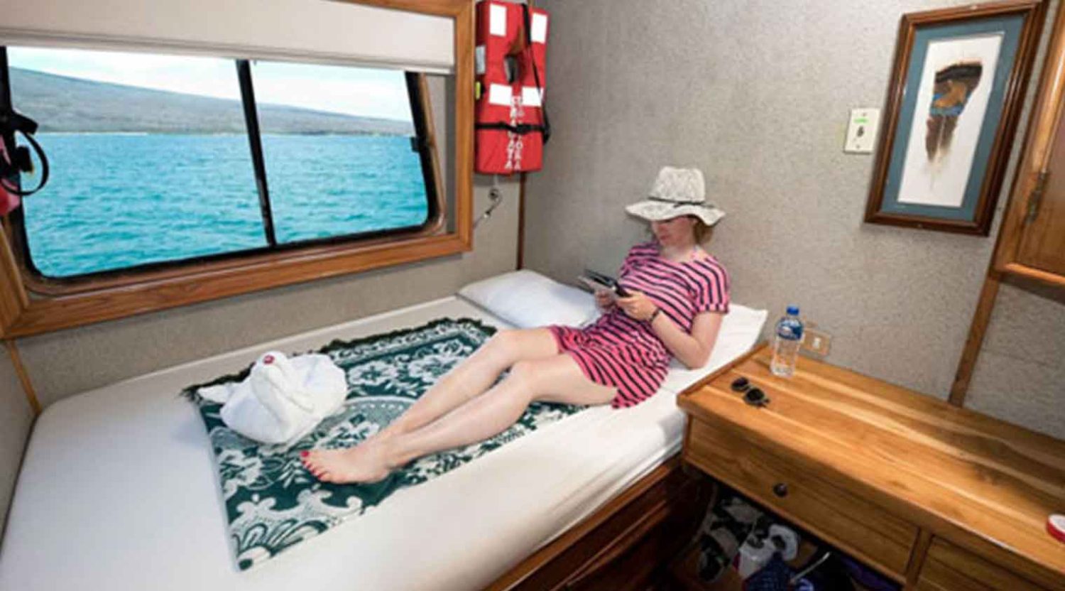 queen size bed bedroom of fragata yacht of galapagos islands tours