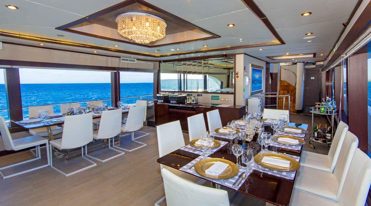 grand majestic galapagos yacht dining room in the day of galapagos islands tours