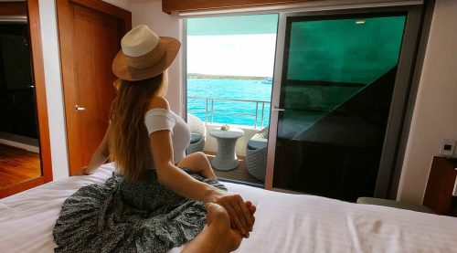 couple taking a photo in infinity yacht of galapagos islands tours