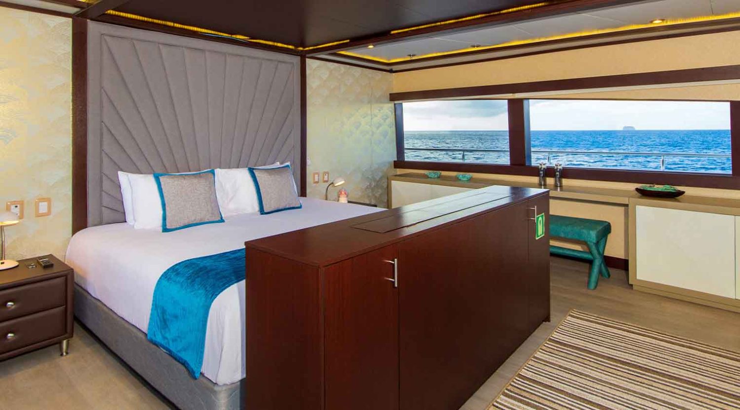 Grand Majestic Galapagos Yacht queen-size bed bedroom of galapagos islands tours