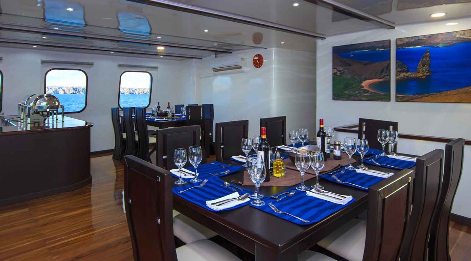 indoor dining room of natural paradise yacht of galapagos islands tours