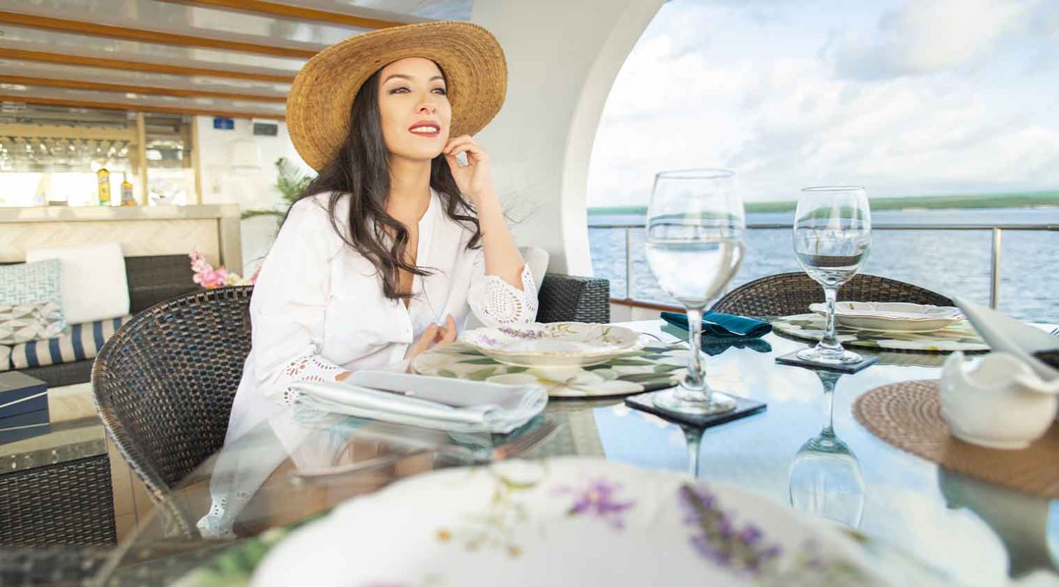 woman having lunch in the dining room of stella maris yacht of galapagos islands tours